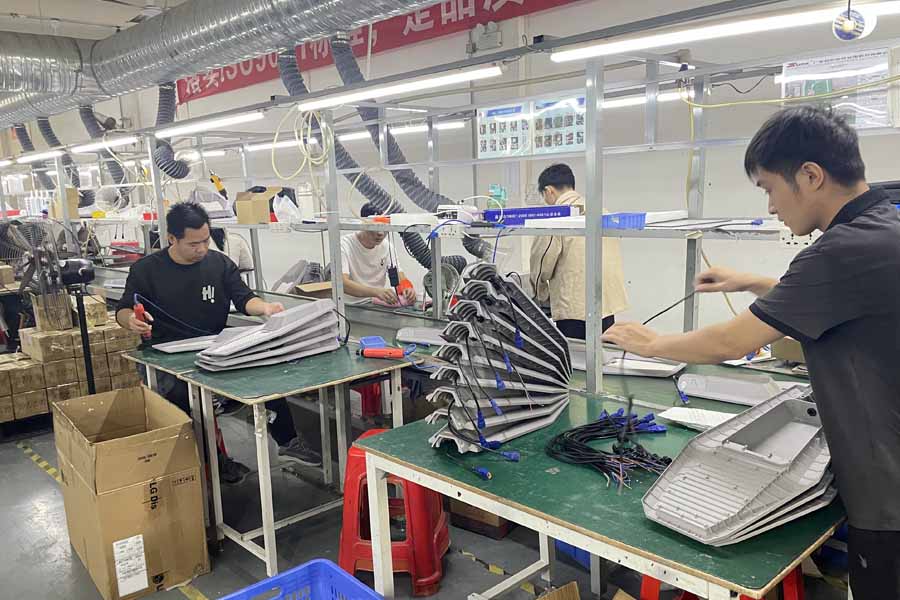 Automated solar street light assembly and production line at solar lighting manufacturer - Lumin Solar Solutions‘ factory.