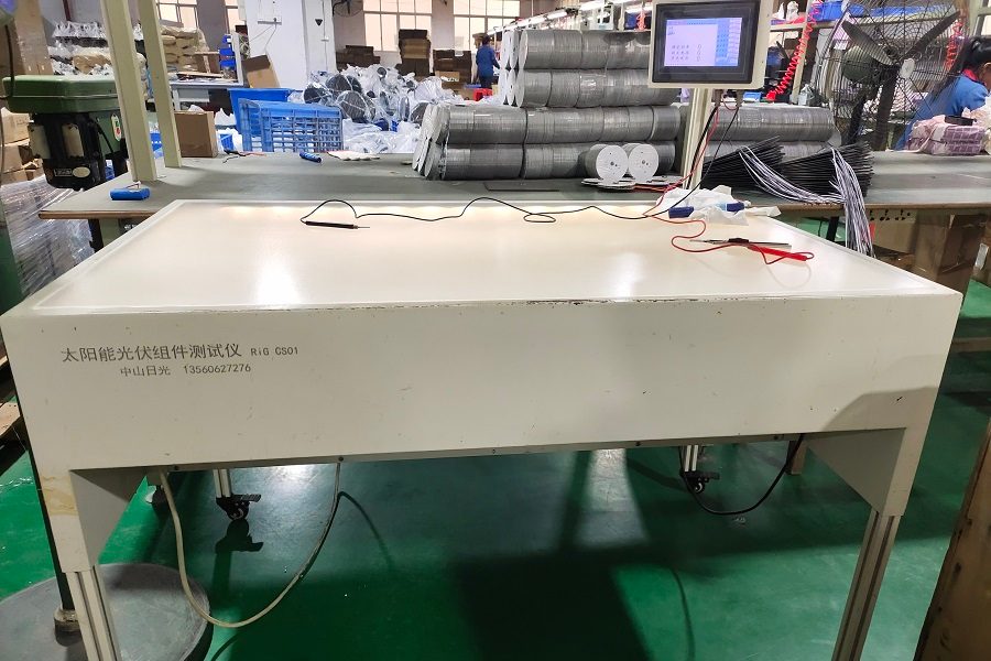 Automated solar panel IV curve tracer verifying power output of PV modules at Lumin Solar Solutions factory.